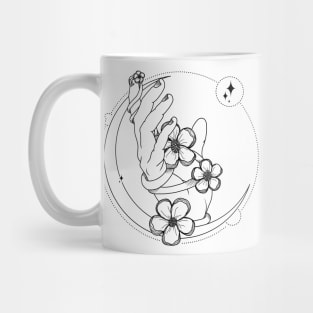 hand holding flower on a crescent moon Mug